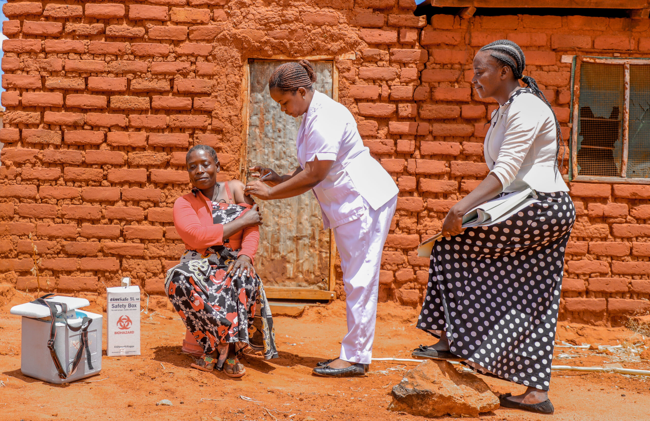 Community Engagement Increases COVID Vaccination Rates In Tanzania   Christine Matinya Right Receives COVID Vaccine From Nahali Modesti Center The Health Service Provider As Amani Mwalimu Looks On Scaled 